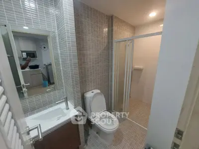 Modern bathroom with sleek fixtures and glass shower enclosure