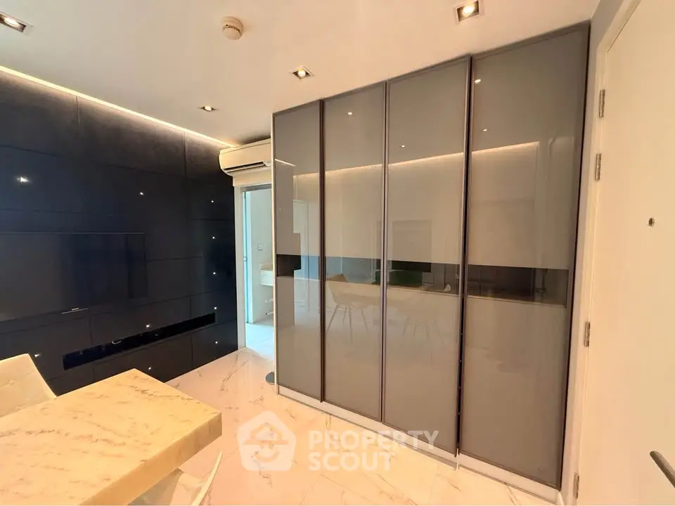 Modern interior with sleek design featuring marble table and built-in storage in a stylish living space.