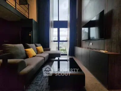Luxurious high-ceiling living room with modern decor and city view