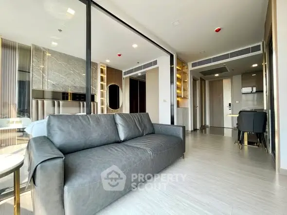 Modern open-plan living room with sleek furniture and stylish decor in a contemporary apartment.