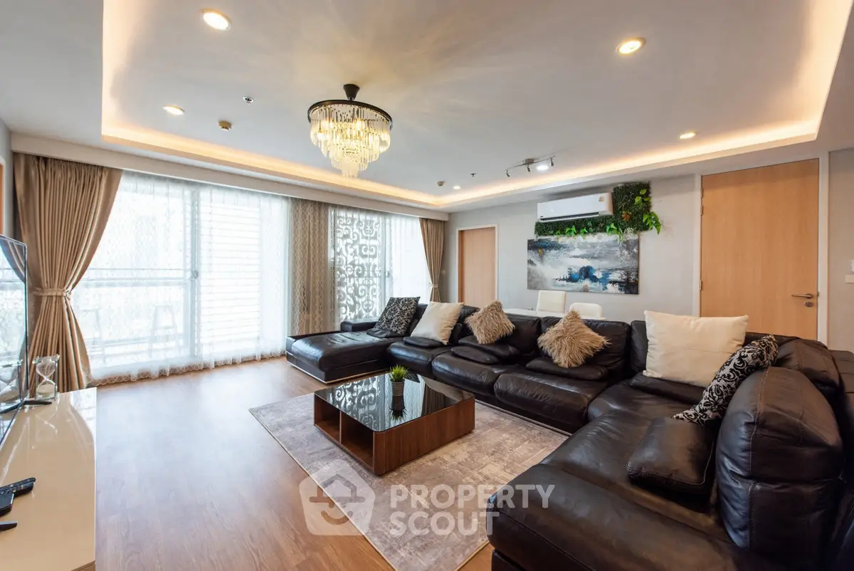 Luxurious living room with elegant chandelier and spacious seating area