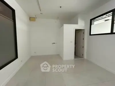 Spacious empty room with white walls and tiled floor, ready for customization.