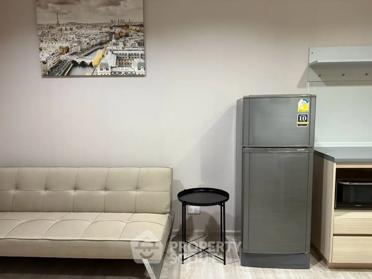 Modern living room with sleek sofa, stylish fridge, and chic decor