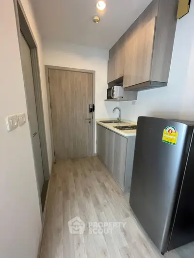 Modern compact kitchen with sleek cabinets and stainless steel appliances