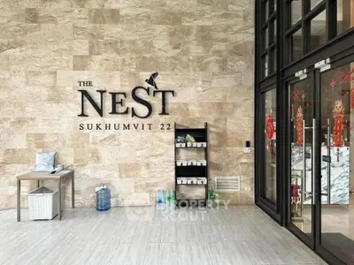 Modern entrance of The Nest Sukhumvit 22 with stylish decor and welcoming ambiance.