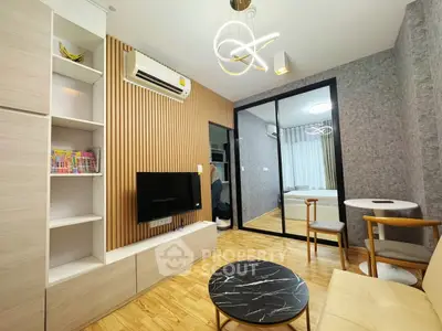 Modern living room with stylish decor and mirrored wall
