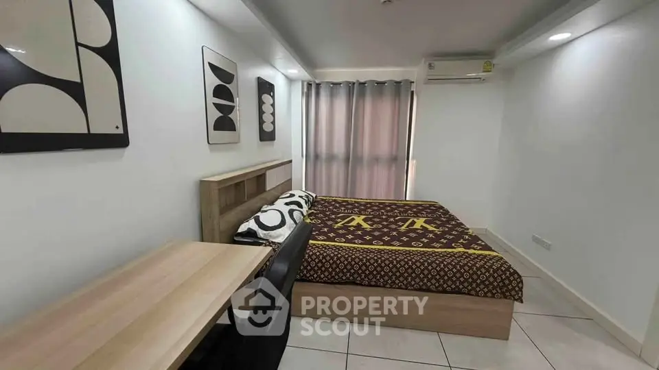 Modern bedroom with stylish decor and cozy ambiance, featuring a comfortable bed and sleek desk.