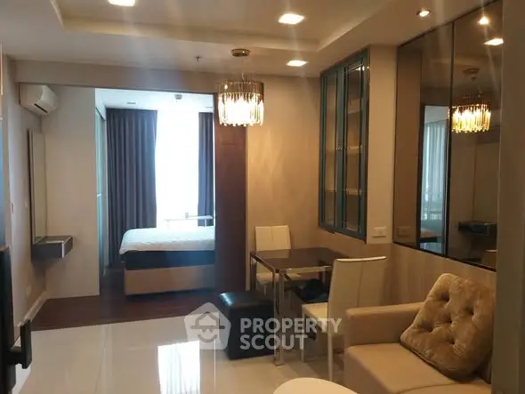 Modern open-plan living room with elegant lighting and cozy seating area.