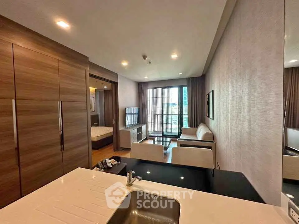 Modern living room with open layout and stylish furnishings in a high-rise apartment.