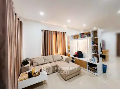 Modern living room with cozy sectional sofa and stylish shelving unit, perfect for relaxation and entertainment.