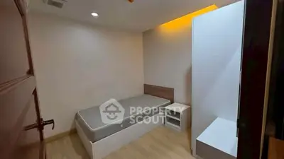Cozy minimalist bedroom with modern lighting and wooden flooring