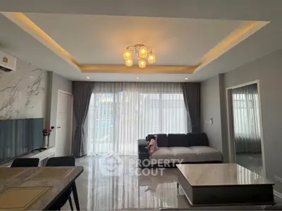 Modern living room with elegant lighting and large windows