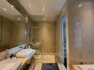 Luxurious modern bathroom with dual sinks and glass shower enclosure