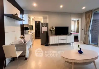 Modern open-plan living room with stylish decor and kitchen view