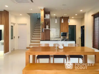 Modern kitchen and dining area with wooden furniture and sleek design