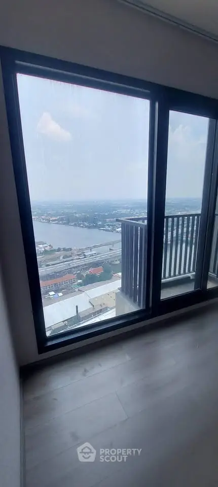 Stunning high-rise apartment with breathtaking river view from large window.