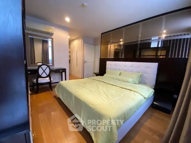 Spacious bedroom with modern decor and elegant furnishings in a stylish apartment.