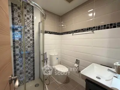Modern bathroom with glass shower and stylish tile design