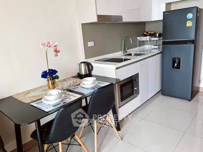 Modern kitchen with sleek appliances and dining area in stylish apartment
