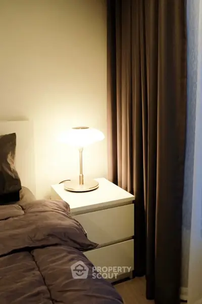 Cozy bedroom corner with soft lighting and elegant curtains