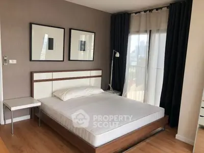 Modern bedroom with stylish decor and large windows offering natural light.