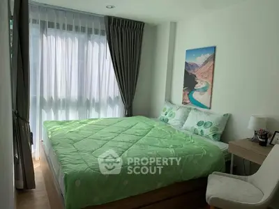 Cozy bedroom with large window and green bedding in modern apartment