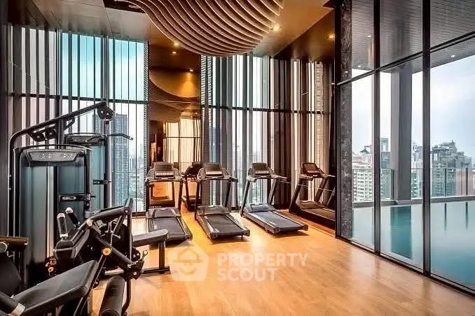 Luxurious high-rise gym with panoramic city views and modern fitness equipment.