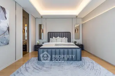 Luxurious modern bedroom with elegant decor and ambient lighting, featuring a plush bed and stylish furnishings.