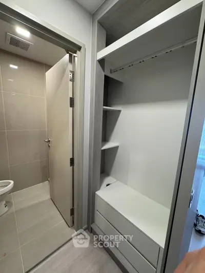 Modern bathroom with sleek storage unit and neutral tones