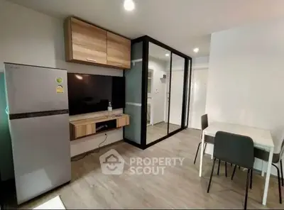 Modern living room with sleek design, featuring a large TV, dining area, and stylish wooden accents.