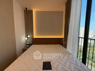 Luxurious bedroom with city view and modern lighting in high-rise apartment
