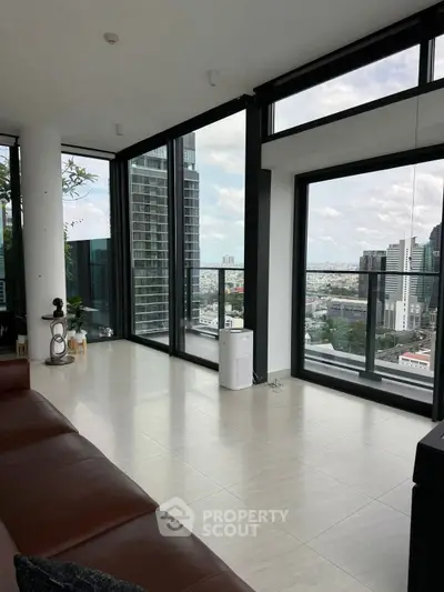 Luxurious living room with floor-to-ceiling windows and stunning city view.