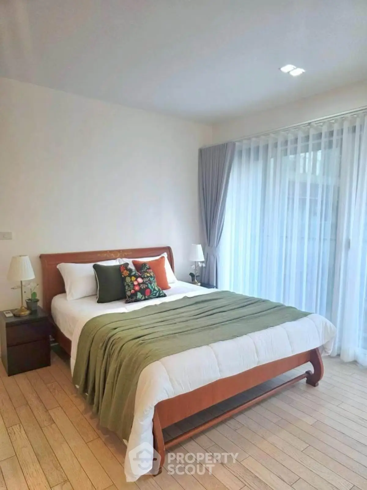 Spacious bedroom with elegant decor and large window for natural light