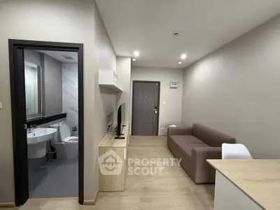 Modern apartment interior with cozy living area and bathroom view