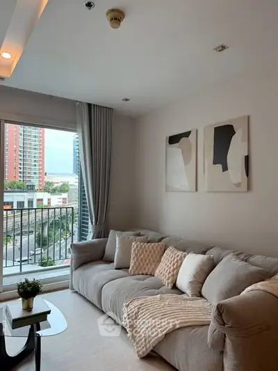 Cozy living room with modern decor and city view from window.