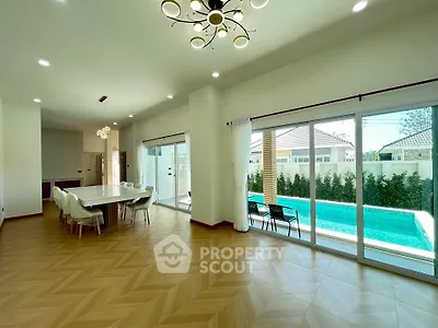 Spacious modern living room with pool view and elegant dining area
