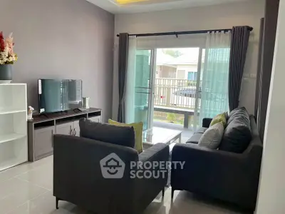 Modern living room with sleek furniture and large window for natural light.