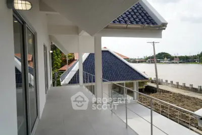 Stunning riverside property with spacious balcony and modern architecture, offering serene water views and elegant design.