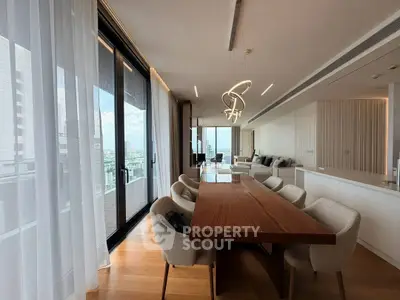 Luxurious modern dining area with floor-to-ceiling windows and elegant lighting in a high-rise apartment.