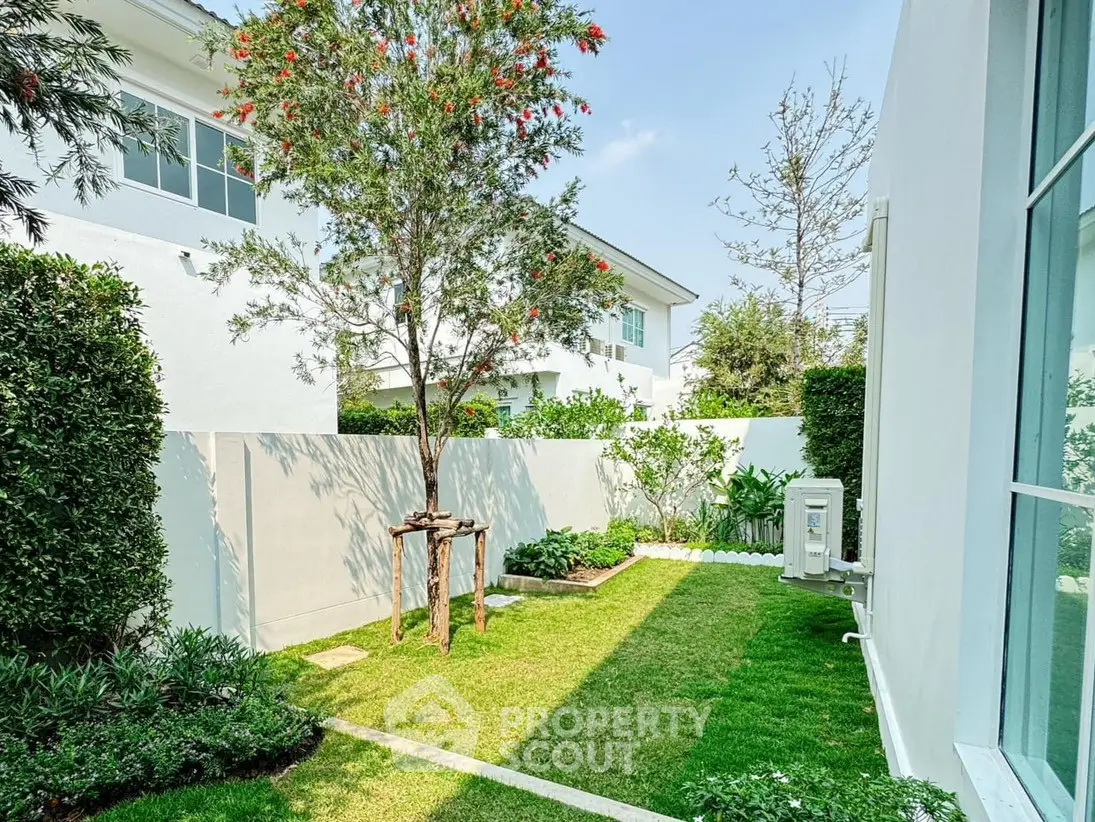 Charming garden view with lush greenery and modern white exterior