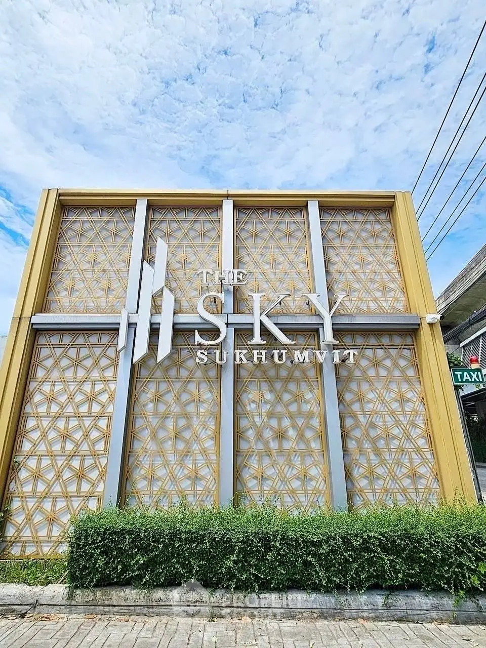 Modern architectural facade of The Sky Sukhumvit with intricate design under a clear blue sky.