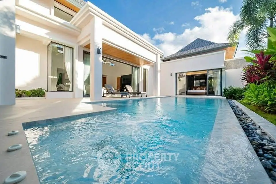 Luxurious villa with private pool and modern architecture in tropical setting.