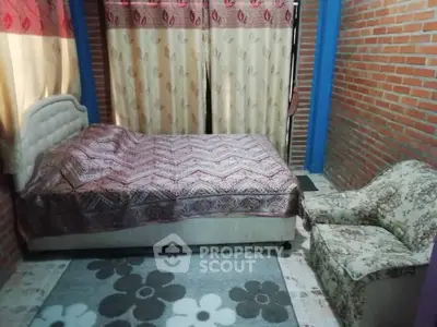 Cozy bedroom with brick walls and floral decor