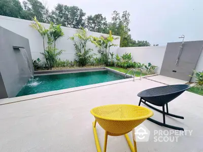 Luxurious private pool with modern design and outdoor shower in serene garden setting.