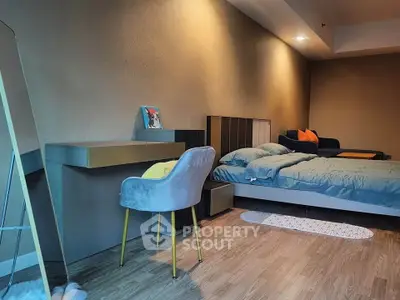 Modern bedroom with stylish decor and cozy ambiance, featuring a comfortable bed and sleek furniture.