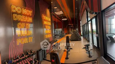Modern gym with motivational neon signs and panoramic windows in luxury building.