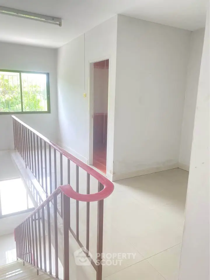 Bright stairway with natural light and sleek railing in modern building