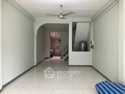 Spacious interior with staircase and ceiling fan, ideal for customization.