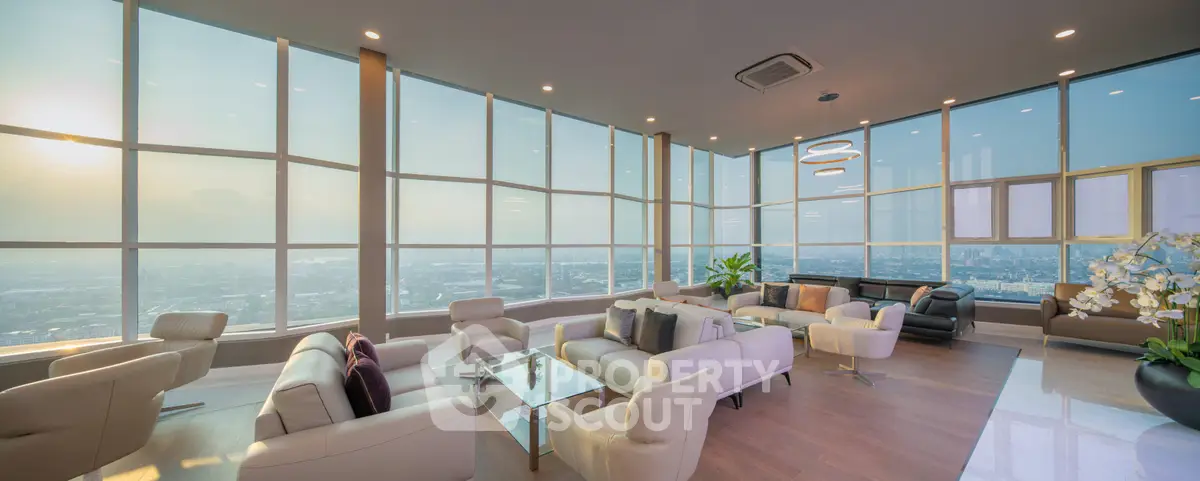 Luxurious penthouse living room with panoramic city views and modern furnishings.