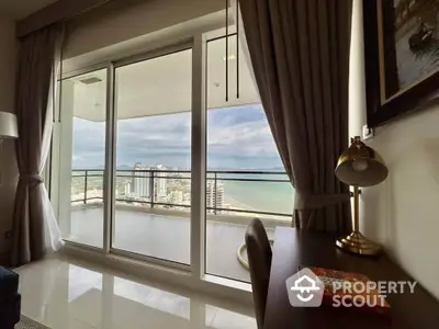 Luxurious high-rise apartment with stunning ocean view from spacious balcony.